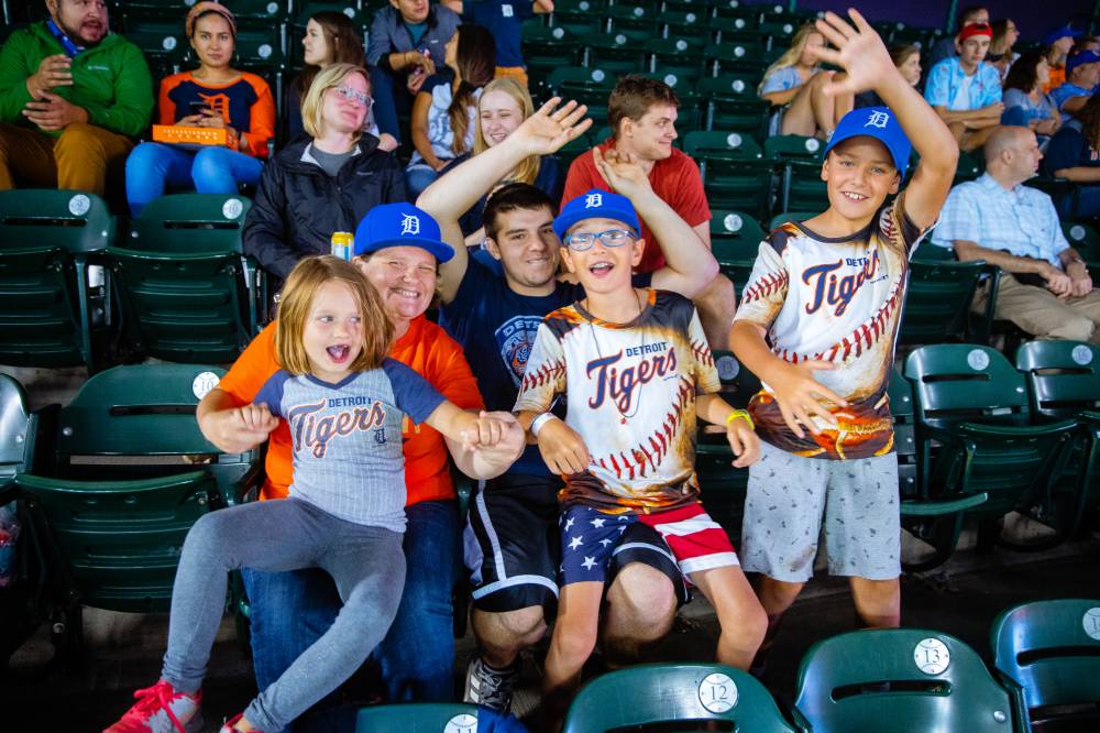 Photo of a family with Detroit Tigers jerseys cheering in the audience pt. 2